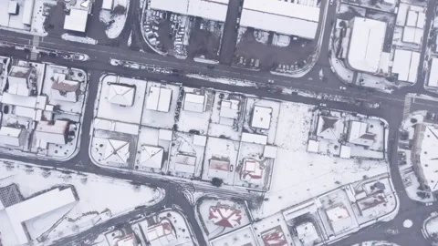 Top down aerial view of snowy rooftops and city streets The Concept of Urba.. Stock Footage 327288402