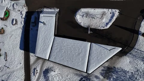 Top-down aerial view of a snowy roof with long shadows Vídeos de archivo 328249507