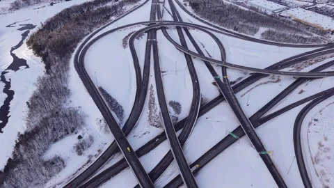 Top down aerial view of snowy highway network with moving vehicles Stock Footage 328963087