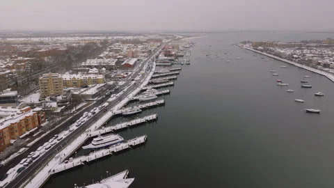 Top down aerial view of snowy marina docks and boats, ProRes 422HQ footage Stock Footage 332695013