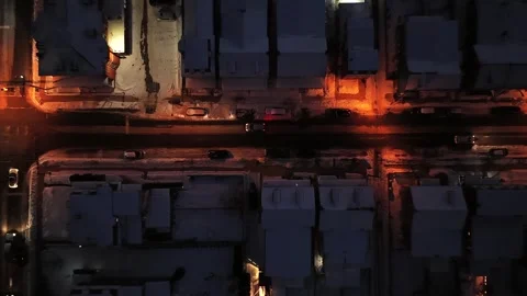 Top down aerial view of snowy American neighborhood at winter night with orange Vidéo 334604991
