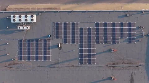 Top down aerial view of solar panels on a building roof 스톡 동영상 348155902