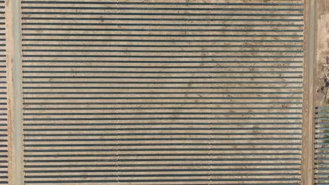 Top down aerial view of solar panel rows forming a geometric grid pattern i.. Stock Photos