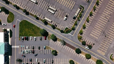 Top-down aerial view of a spacious urban parking lot filled with parked... 動画素材 340657928