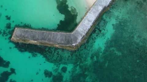 Top-down aerial view of stone pier in clear tropical sea, Philippines Stock Footage 325217616