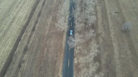 Top down aerial view of straight road through textured dry landscape in China Stock Footage 337861814