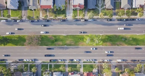 Top down aerial view of suburban neighborhood street city traffic Stock Footage 92875863