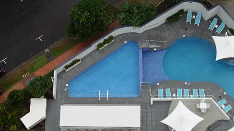 Top-Down Aerial View of Swimming Pools on Windy Day With Trees Swaying Stock Footage 329357822