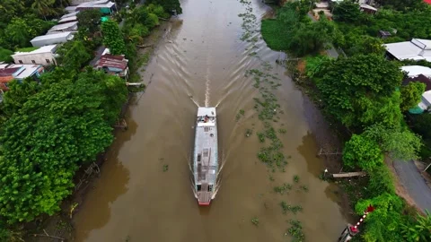 Top-down aerial view tracking cargo boat navigating along river Stock Footage 342924420