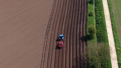 Top Down Aerial View of Tractor Ploughing Soil Furrows in Yorkshire UK Stock Footage 346140255