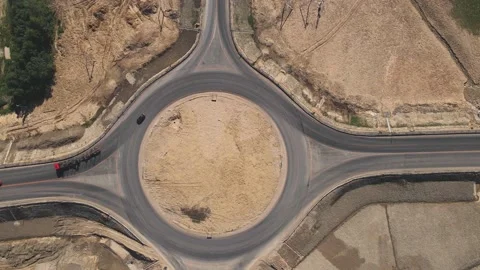 Top down aerial view of a traffic roundabout. Camera departure. Stock Footage 157389134