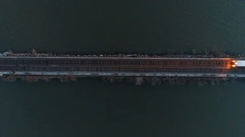 Top Down Aerial View of Train Passing on Tracks Over the Hudson River Stock Footage 94657195