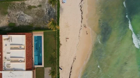 Top down aerial view of tropical waves crashing on a white sand beach with 스톡 동영상 229218396