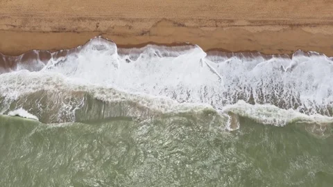 Top-down aerial view of turquoise ocean waves on a sandy beach in Lome, Togo Stock Footage 330972928