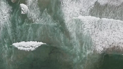 Top down aerial view of turquoise ocean waves and foam Stock Footage 336025329