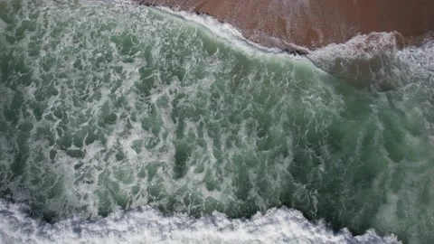 Top down aerial view of unidentifiable surfer swimming on his board on the water Stock Footage 234639811