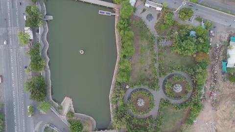 Top Down Aerial View of Urban Park with Lake, Walking Paths and Circular Gar Stock-Footage 337959549