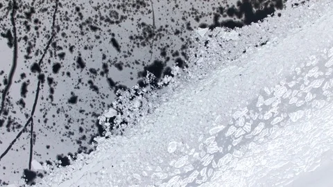 Top-down aerial view of variable patterns formed by broken ice floes at a frozen Stock Footage 86179393