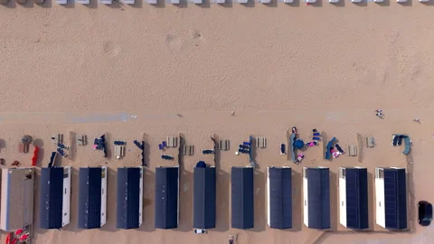 Top down aerial view video clip of modern beach houses, wooden tables sun Stock Footage 341486847