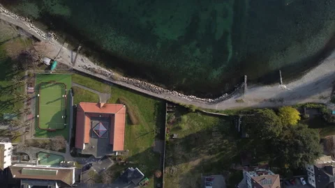 Top down aerial view of walking path along the Lake Geneva waterfront in Stock Footage 157744532