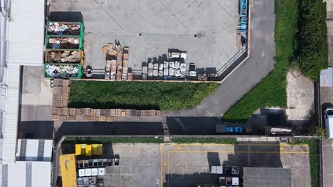 Top-down aerial view of a waste storage and sorting area with multiple Stock Footage 346882504