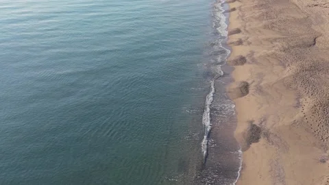 Top Down Aerial View of Waves Meeting Sandy Beach Stock Footage 325292779