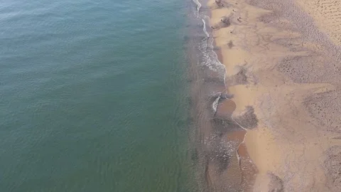 Top Down Aerial View of Waves Meeting Sandy Beach Stock Footage 325292781