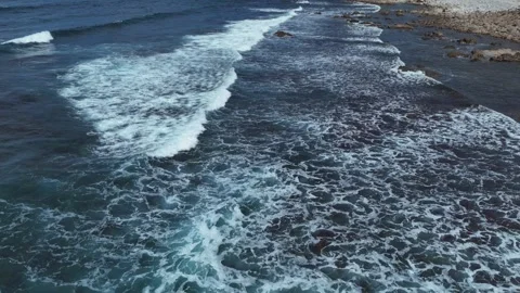 Top-Down Aerial View of Waves Crashing on Rocky Coastal Cliffs Stock-Footage 345841092