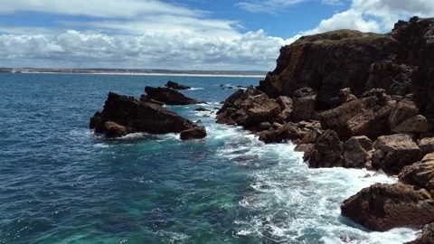 Top-Down Aerial View of Waves Crashing on Rocky Coastal Cliffs Stock-Footage 345841109