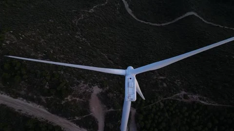 Top-down aerial view of wind turbine blades rotating for renewable energy Stock Footage 327127641