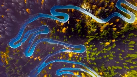 Top Down Aerial View of Winding Mountain Pass Road in Autumn Forest Stock Footage 346732044