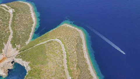 Top down aerial view of winding coastal road leading to Cape Lefkatas with .. Stock Photos