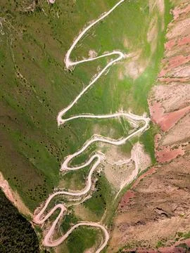 Top down aerial view of winding Teskey Torpok mountain road near Song Kul i.. Stock Photos