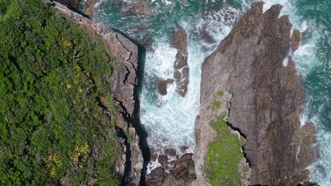 Top Down Aerial Waves Crashing on Rocky Cliffs at Poca da Tartaruga Buzios Stock Footage 332090259