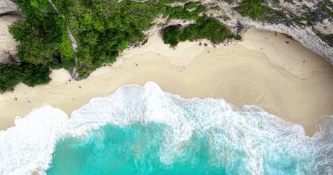 Top Down Aerial of Waves on Sandy Beach at Kelingking Beach, Nusa Penida Bali Stock Footage 331213422