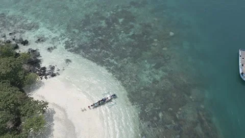 Top Down Aerial Of White Sand Spit Black Rocks And Boats Lampung Stock Footage 337047269