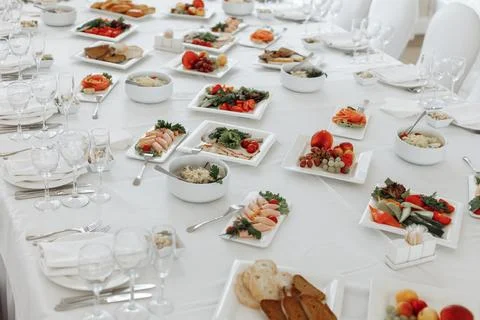 Top-down angled view of a beautifully served festive table with white plates Stock Photos
