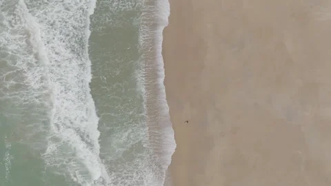Top-down backward tracking beach sand sea Stock Footage 345216698