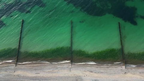 Top Down Baltic Sea Beach with Wooden Groynes and Turquoise Water Stock Footage 341887619