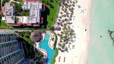Top down beach with hotels, pool, and turqouise water 4K Stock Footage 314753926