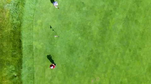 Top Down Birds Eye View of Golfers on Putting Green with Flagstick Stock Footage 337656981