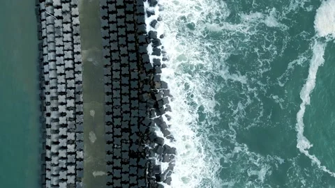 Top down birdseye view ocean waves breaking on harbor wall porto portugal Stock Footage 219988474