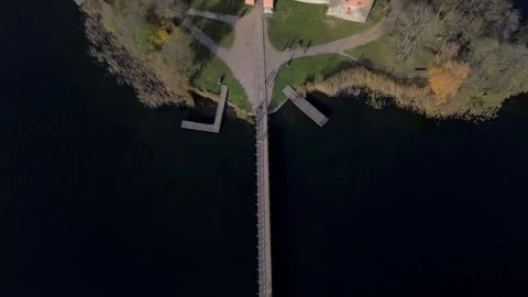 Top down of the bridge over Galve lakes leading to Trakai castle island Stock Footage 255928241