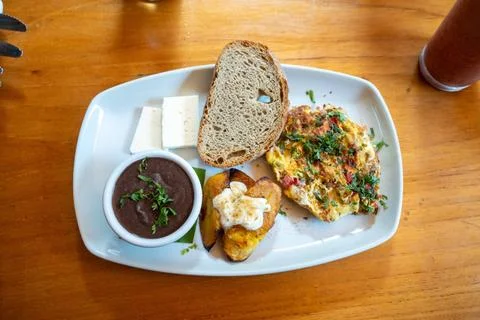 Top down capture of organic breakfast plate with eggs, plantains with chees.. Photos