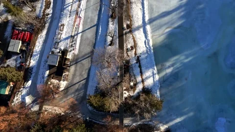 Top Down cinematic Aerial View of Frozen Bowness Park in Calgary Alberta Видео 336354911