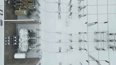 Top Down Close Aerial of Snow Covered Power Transformers in Electrical Stock Footage 328816236