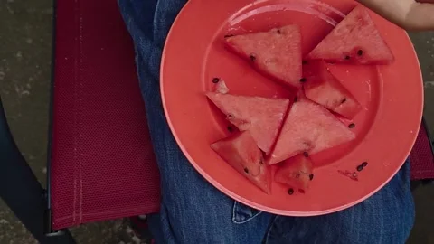 Top Down Close Up of Child Hand Taking Fresh Watermelon Slice Red Plate Stock Footage 345309947