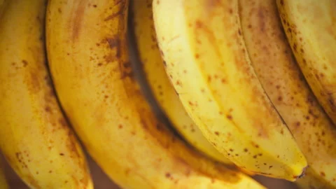 A top-down close-up of a dense cluster of yellow bananas filling the frame w Stock Footage 337938202