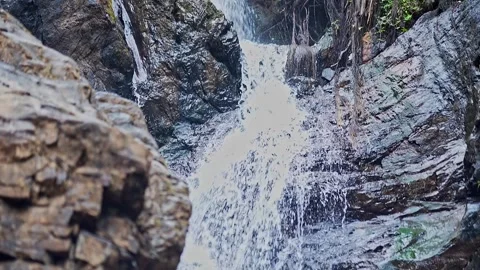 Top-down close-up of fresh mountain water cascading off a rocky cliff in Ka.. Stock Footage 313381123