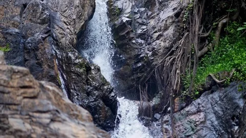 Top-down close-up of fresh mountain water cascading off a rocky cliff in Ka.. Stock Footage 313381124